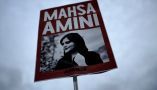 A placard with a picture of Mahsa Amini, whose death while being detained by Iran’s morality police has ignited a wave of protests across the country. (AP Photo/Markus Schreiber)