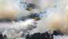 Dos avionetas vierten agua sobre el incendio forestal de La Mierla, Guadalajara, en julio de 2026. Staurrahmanstudio/Shutterstock