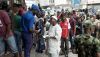 People queue outside a bank in Lagos on February 22, 2023. Nigeria was hit with a scarcity of cash after the central bank began to swap old Naira notes for new bills. Patrick Meinhardt / AFP