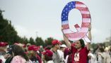 A protester holds a Q sign as he waits to enter a campaign rally with then-President Donald Trump in Wilkes-Barre, Pa., in August 2018. AP Photo/Matt Rourke
