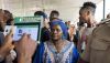 An election official uses the Bimodal Voter Accreditation System to take a picture of a voter during Nigeria’s presidential election. Patrick Meinhardt/Getty Images