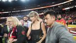 Taylor Swift, flanked by security guards and Donna Kelce, mother of her boyfriend, Travis Kelce, appears at the Super Bowl in February 2024. Julio Cortez/AP