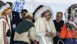 Pope Francis receives a traditional headdress after apologizing near the site of the former Ermineskin Residential School, in Maskwacis, Alta. THE CANADIAN PRESS/Jason Franson