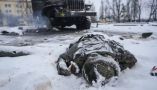 A soldier’s body lies next to a destroyed Russian truck on the outskirts of Kharkiv, Ukraine, on Feb. 25, 2022. AP Photo/Vadim Ghirda