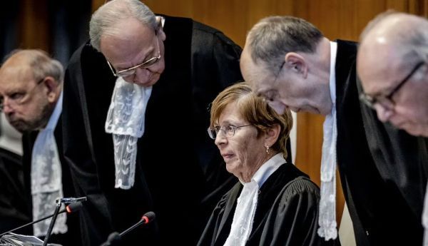 International Court of Justice President Joan Donoghue, center, and other judges arrive prior to the preliminary order announcement on Jan. 26, 2024. Remko De Waal/ANP/AFP via Getty Images 