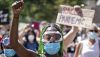 A woman raises her fist during a 2020 Black Lives Matter protest in Queens, New York. Ira L. Black/Corbis via Getty Images