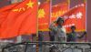 A military officer salutes during a parade to commemorate the anniversary of the founding of Communist China in Beijing. Mark Schiefelbein/AP
