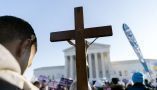 Anti-abortion protesters holding a cross demonstrate in front of the Supreme Court Building in December 2021, in Washington. AP Photo/Jose Luis Magana