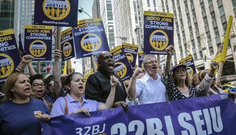 Members of a union representing workers who clean New York City offices march in 2019. AP Photo/Bebeto Matthews