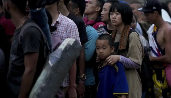 Chinese migrants wait for a boat after having walked across the Darien Gap from Colombia to Panama. AP Photo/Natacha Pisarenko