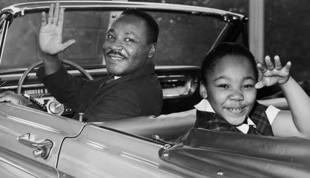 Martin Luther King Jr. waves with his children, Yolanda and Martin Luther III, from the 1964 World’s Fair in New York City. Photo by Hulton Archive/Getty Images