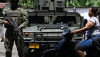 Soldiers guard a road after the Colombian government accused the Gulf Clan criminal organization of supporting attacks by illegal gold miners. Raul Arboleda/AFP via Getty Images