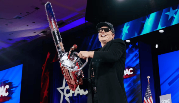 Elon Musk poses with a chainsaw at the CPAC conference. Will Oliver/Pool/EPA