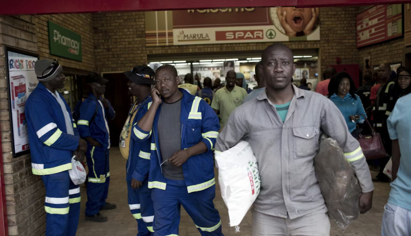 Workers shop in a grocery store in Maropong township outside Lephalale, South Africa. Per-Anders Pettersson/Getty Images