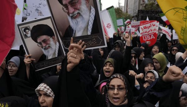 Holding posters of the Iranian Supreme Leader Ayatollah Ali Khamenei, demonstrators chant slogans in an annual rally in front of the former U.S. Embassy in Tehran on Nov. 3, 2024. AP Photo/Vahid Salemi