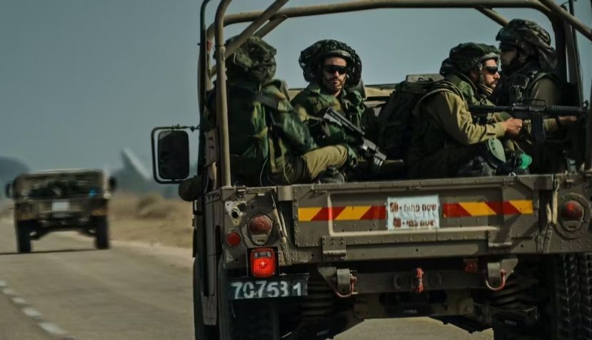 Israeli soldiers ride on a transport vehicle near Re'im, Israel, on Oct. 10, 2023. Marcus Yam/ Los Angeles Times