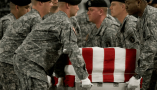 The body of U.S. Army Spc. Israel Candelaria Mejias is carried in a transfer case at Dover Air Force Base in Delaware after he was killed on April 5, 2009, near Baghdad. AFP Photo/Paul J. Richards via Getty Images