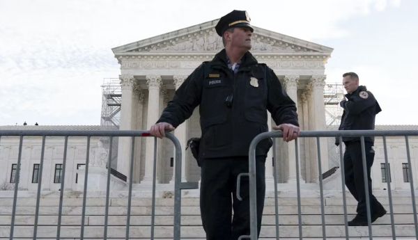 Police place a fence at the U.S. Supreme Court on Feb. 8, 2024, before justices heard arguments over whether Donald Trump is ineligible for the 2024 ballot. AP Photo/Jose Luis Magana
