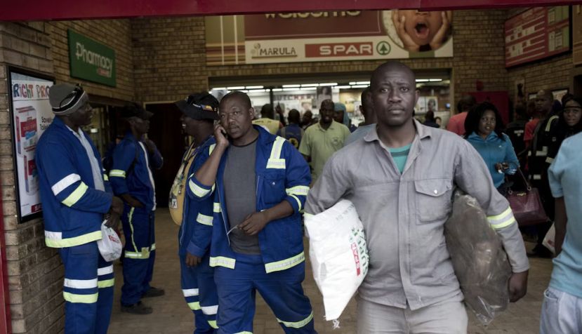 Workers shop in a grocery store in Maropong township outside Lephalale, South Africa. Per-Anders Pettersson/Getty Images