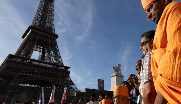 Monks from Bochasanwasi Akshar Purushottam Swaminarayan Sanstha, a Hindu group, take part in a religious ceremony in front of the Eiffel Tower in Paris on Sept. 3, 2026. Kenzo Tribouillard / AFP via Getty Images